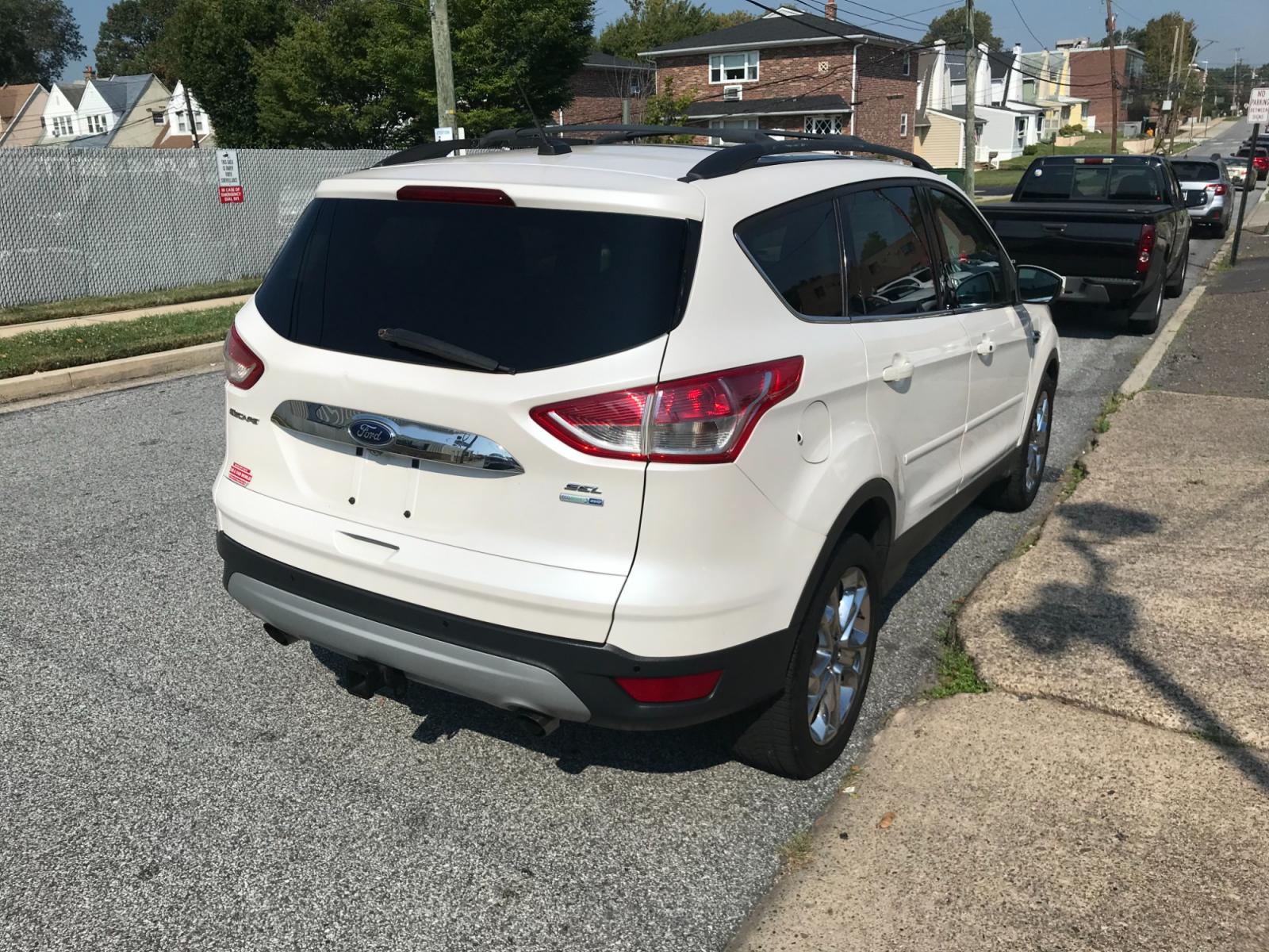 2013 White /Tan Ford Escape SEL 4WD (1FMCU9H92DU) with an 2.0L L4 DOHC 16V engine, 6-Speed Automatic transmission, located at 577 Chester Pike, Prospect Park, PA, 19076, (610) 237-1015, 39.886154, -75.302338 - 13 Ford Escape SEL: 4x4, sunroof, nice radio w/ bluetooth, dual exhaust, trailer hitch, looks and runs LIKE NEW! This vehicle comes inspected and has been given a bumper to bumper safety check. It is very clean, reliable, and well maintained. We offer a unique pay plan that is known for being the - Photo #4