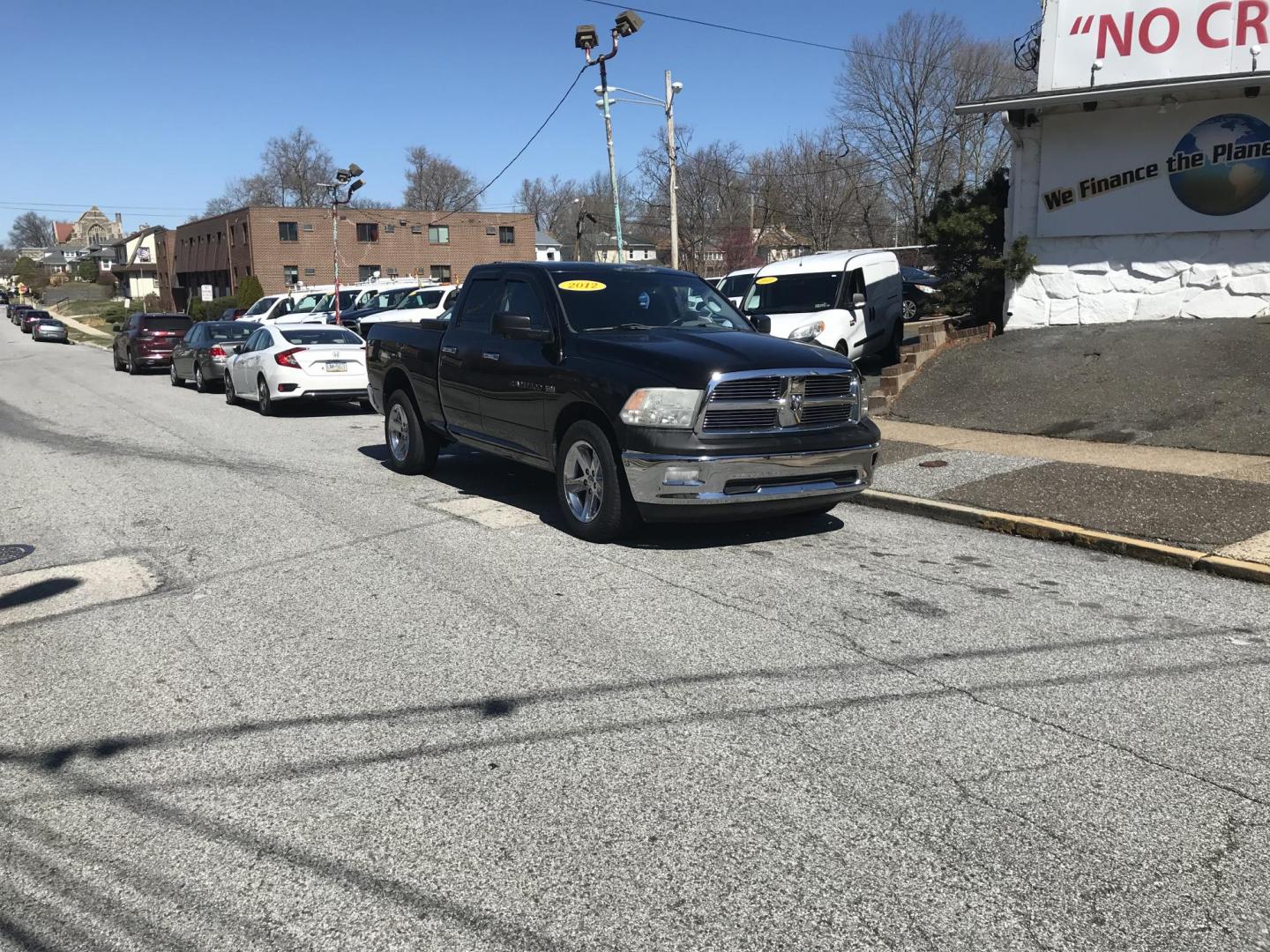 2012 Black /Tan Dodge Ram 1500 SLT Quad Cab 4WD (1C6RD7GT9CS) with an 5.7L V8 OHV 16V engine, 5-Speed Automatic transmission, located at 577 Chester Pike, Prospect Park, PA, 19076, (610) 237-1015, 39.886154, -75.302338 - Photo#1