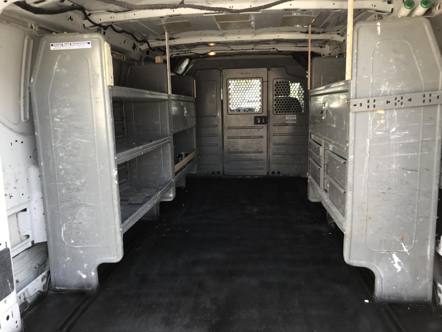 2015 White /Gray Ford Transit 150 Van Low Roof 60/40 Pass. 148-in. WB (1FTNE9ZM7FK) with an 3.7L V6 DOHC 24V engine, 6-Speed Automatic transmission, located at 577 Chester Pike, Prospect Park, PA, 19076, (610) 237-1015, 39.886154, -75.302338 - 15 Ford Transit 150: Ladder racks, multiple pieces of shelving, partition, brand new inspection, runs LIKE NEW! This vehicle comes inspected and has been given a bumper to bumper safety check. It is very clean, reliable, and well maintained. We offer a unique pay plan that is known for being the- Photo#14