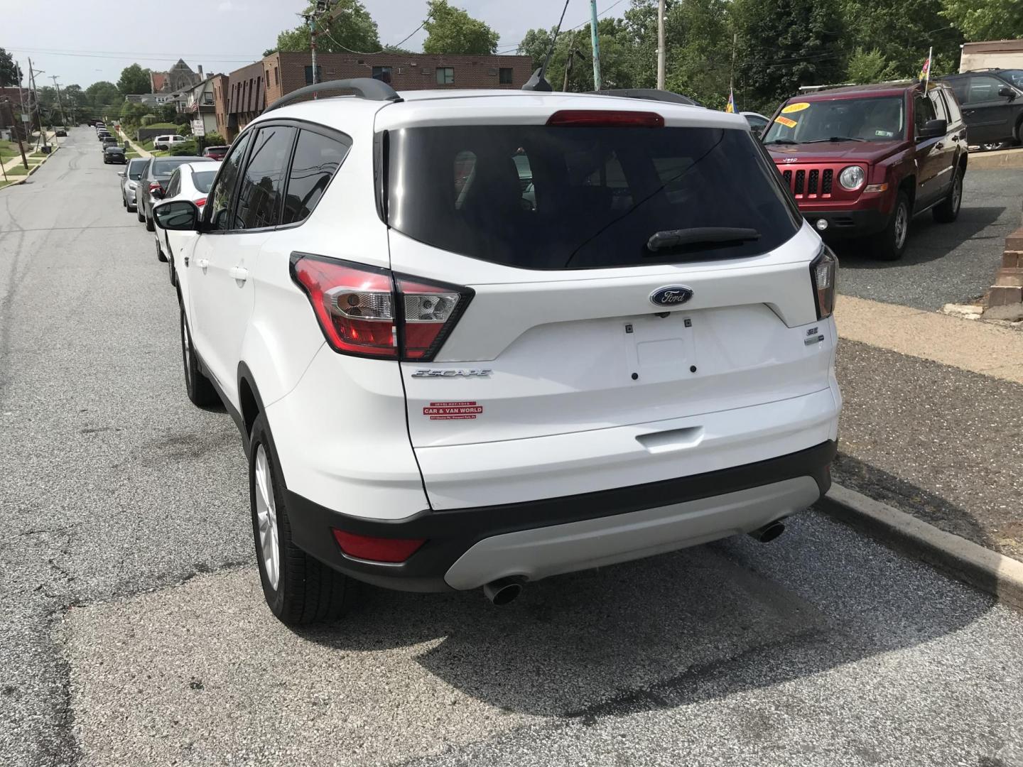 2018 White /Gray Ford Escape SE 4WD (1FMCU9GD7JU) with an 1.5L L4 DOHC 16V engine, 6A transmission, located at 577 Chester Pike, Prospect Park, PA, 19076, (610) 237-1015, 39.886154, -75.302338 - 18 Ford Escape SE: Navigation system, backup camera, looks and runs LIKE NEW! This vehicle comes inspected and has been given a bumper to bumper safety check. It is very clean, reliable, and well maintained. We offer a unique pay plan that is known for being the easiest and fastest financing opti - Photo#5