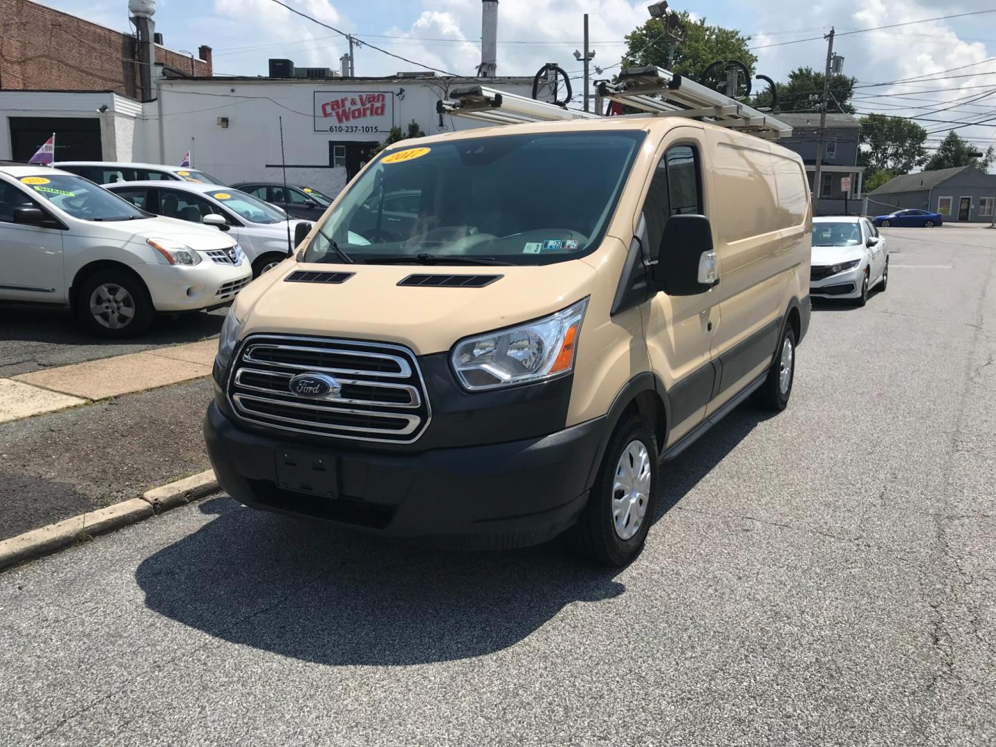 2017 Tan /Gray Ford Transit 150 (1FTYE1YM2HK) with an 3.7 V6 engine, Automatic transmission, located at 577 Chester Pike, Prospect Park, PA, 19076, (610) 237-1015, 39.886154, -75.302338 - 2017 Ford Transit 150 Low Roof: Nice ladder racks that drop down, multiple pieces of shelving, bulkhead, no windows, PA inspection, FLEET MAINTAINED, runs LIKE NEW! This vehicle comes inspected and has been given a bumper to bumper safety check. It is very clean, reliable, and well maintained. We - Photo#2