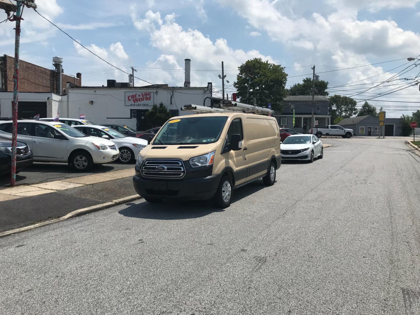 2017 Tan /Gray Ford Transit 150 (1FTYE1YM2HK) with an 3.7 V6 engine, Automatic transmission, located at 577 Chester Pike, Prospect Park, PA, 19076, (610) 237-1015, 39.886154, -75.302338 - 2017 Ford Transit 150 Low Roof: Nice ladder racks that drop down, multiple pieces of shelving, bulkhead, no windows, PA inspection, FLEET MAINTAINED, runs LIKE NEW! This vehicle comes inspected and has been given a bumper to bumper safety check. It is very clean, reliable, and well maintained. We - Photo#1