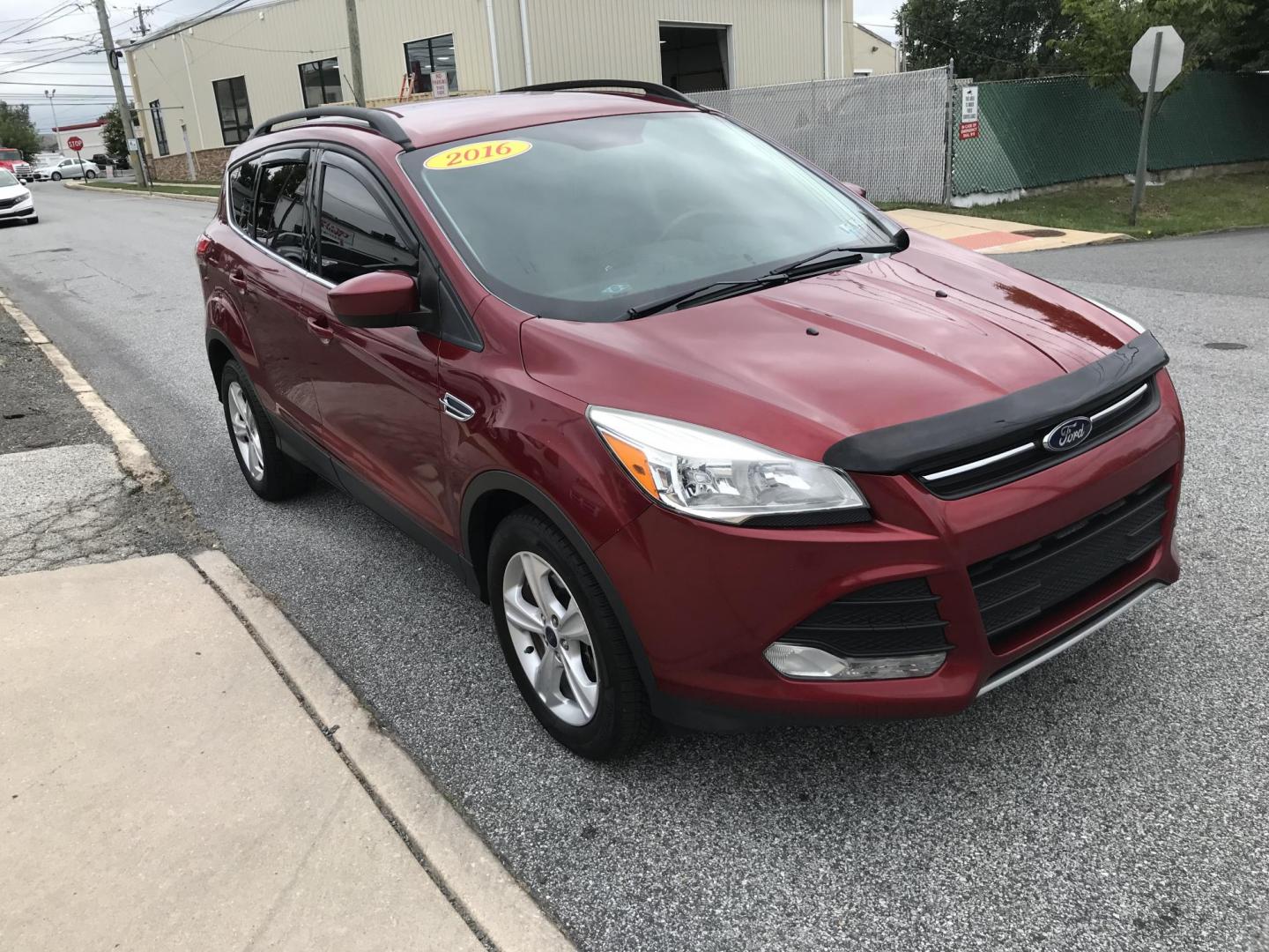2016 Red /Gray Ford Escape SE 4WD (1FMCU9GX4GU) with an 1.6L L4 DOHC 16V engine, 6-Speed Automatic transmission, located at 577 Chester Pike, Prospect Park, PA, 19076, (610) 237-1015, 39.886154, -75.302338 - Photo#2