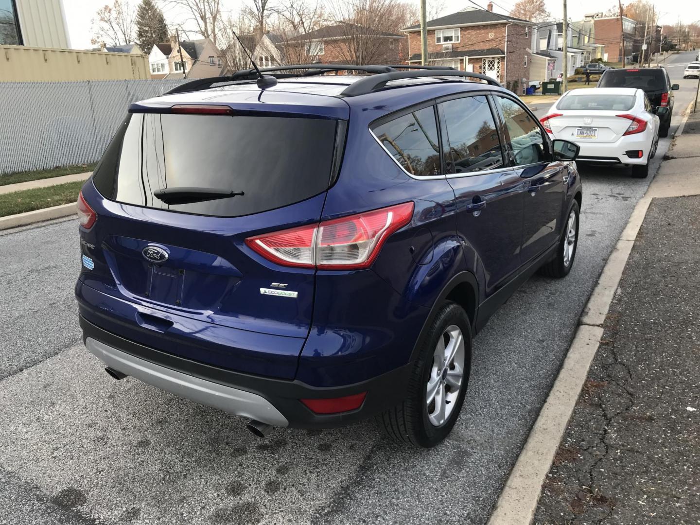 2014 Blue /Gray Ford Escape SE (1FMCU0GX7EU) with an 1.6L L4 DOHC 16V engine, 6-Speed Automatic transmission, located at 577 Chester Pike, Prospect Park, PA, 19076, (610) 237-1015, 39.886154, -75.302338 - Photo#4