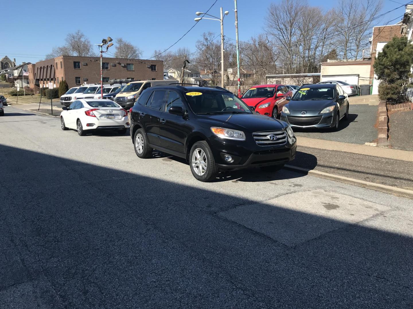 2012 Black /Tan Hyundai Santa Fe Limited 3.5 4WD (5XYZKDAG1CG) with an 3.5L V6 DOHC 24V engine, 6-Speed Automatic transmission, located at 577 Chester Pike, Prospect Park, PA, 19076, (610) 237-1015, 39.886154, -75.302338 - Photo#1