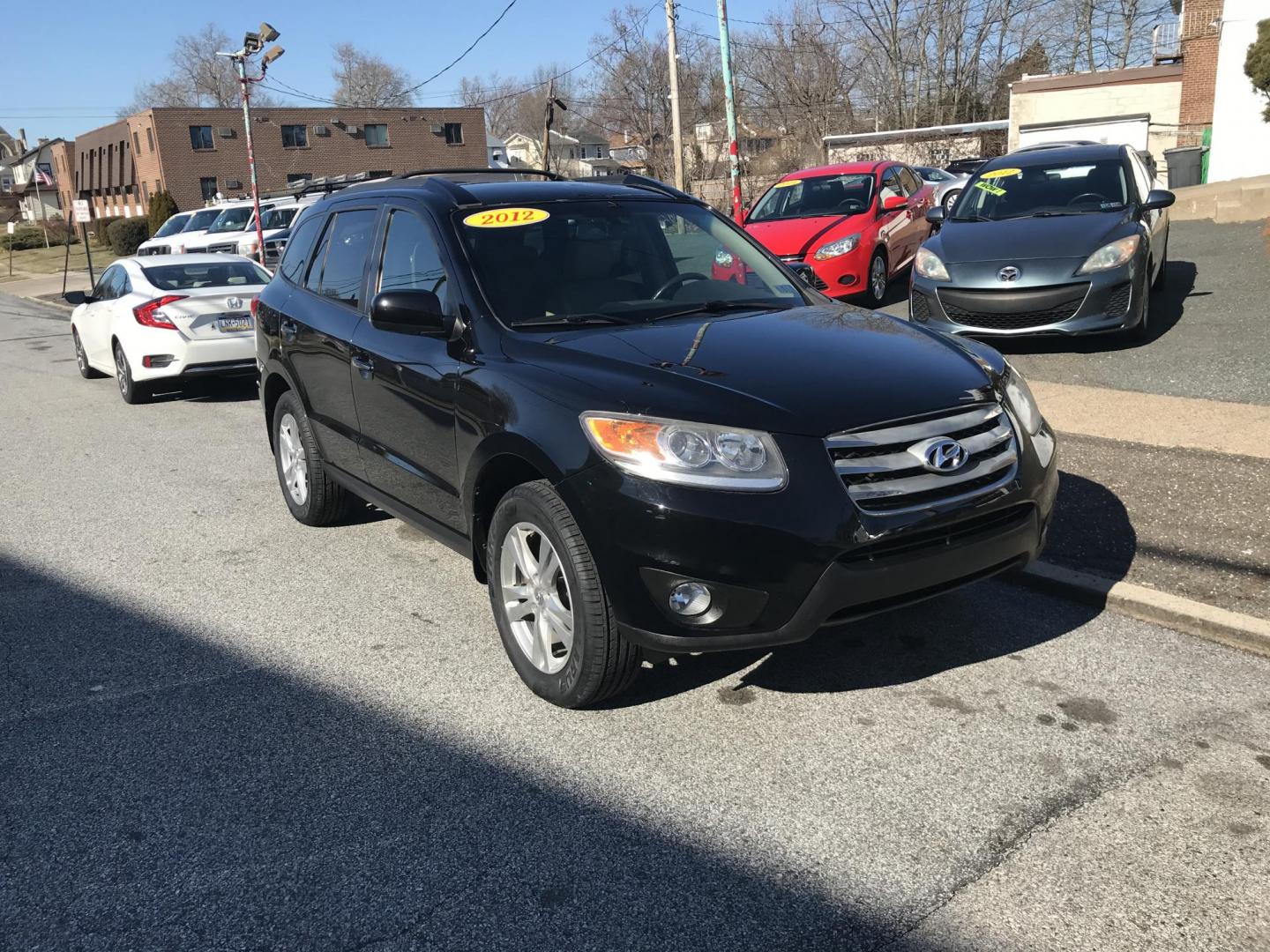 2012 Black /Tan Hyundai Santa Fe Limited 3.5 4WD (5XYZKDAG1CG) with an 3.5L V6 DOHC 24V engine, 6-Speed Automatic transmission, located at 577 Chester Pike, Prospect Park, PA, 19076, (610) 237-1015, 39.886154, -75.302338 - Photo#2