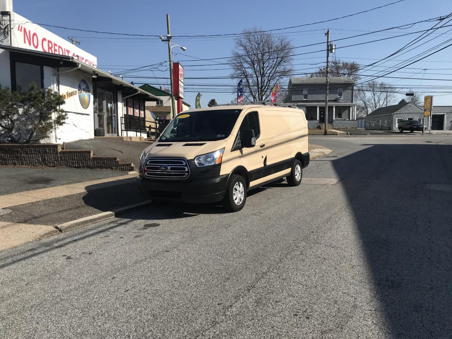 2019 Tan /Gray Ford Transit 150 Van Low Roof w/Sliding Pass. 130-in. WB (1FTYE1YM4KK) with an 3.7L V6 DOHC 24V engine, 6A transmission, located at 577 Chester Pike, Prospect Park, PA, 19076, (610) 237-1015, 39.886154, -75.302338 - Photo#1