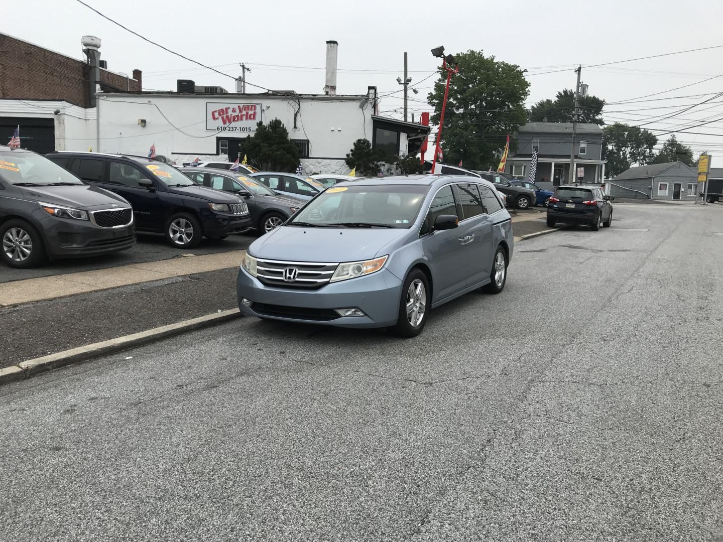 2012 Blue /Gray Honda Odyssey Touring (5FNRL5H9XCB) with an 3.5L V6 SOHC 24V engine, 5-Speed Automatic transmission, located at 577 Chester Pike, Prospect Park, PA, 19076, (610) 237-1015, 39.886154, -75.302338 - 2012 Honda Odyssey Touring 155k miles • DVD Player. Navigation System. Example Financing: • $3,000 Down • $100 Weekly • $200 Bi-Weekly We finance our own vehicles. We do not obtain or review traditional consumer credit reports. Financing decisions are based on verified income, ability- Photo#1