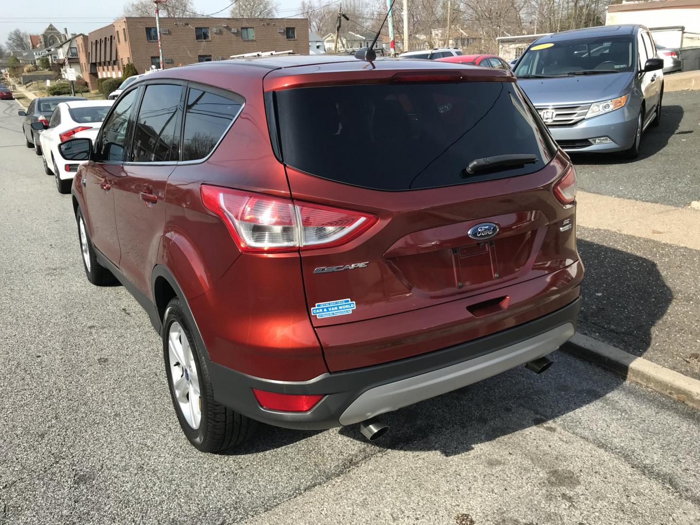 2015 Red /Gray Ford Escape SE 4WD (1FMCU9GX1FU) with an 1.6L L4 DOHC 16V engine, 6-Speed Automatic transmission, located at 577 Chester Pike, Prospect Park, PA, 19076, (610) 237-1015, 39.886154, -75.302338 - 2015 Ford Escape SE: Only 115k miles, 4x4, new PA inspection, great on gas, SUPER CLEAN, runs LIKE NEW! This vehicle comes inspected and has been given a bumper to bumper safety check. It is very clean, reliable, and well maintained. We offer a unique pay plan that is known for being the easiest - Photo#3