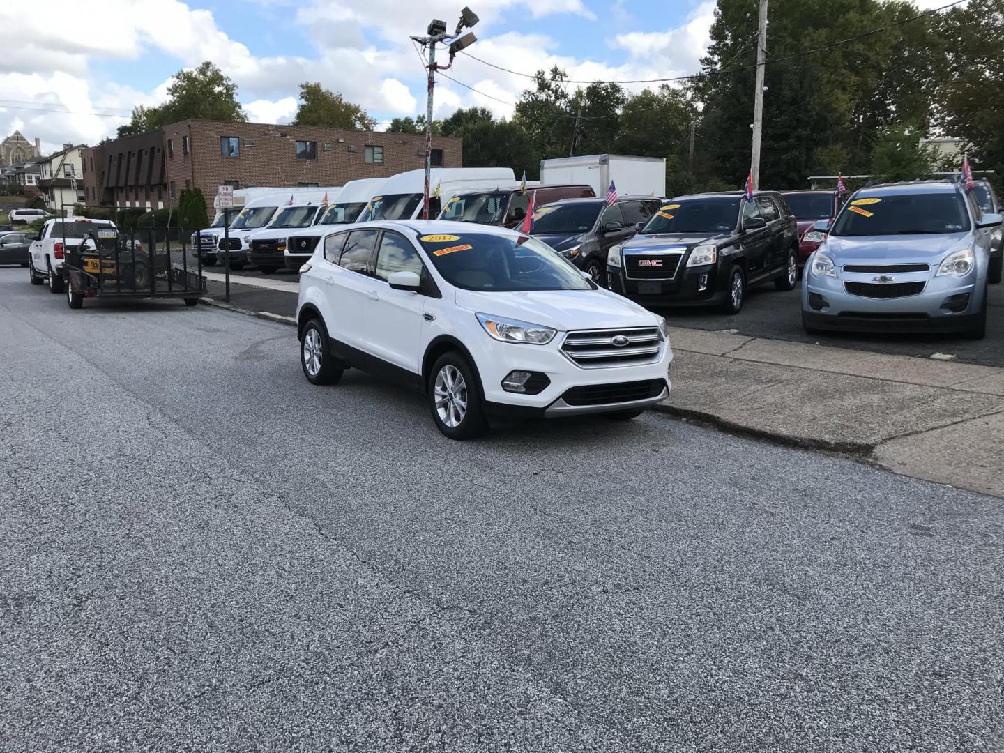2017 White /Tan Ford Escape SE 4WD (1FMCU9GD6HU) with an 1.5L L4 DOHC 16V engine, 6A transmission, located at 577 Chester Pike, Prospect Park, PA, 19076, (610) 237-1015, 39.886154, -75.302338 - 2017 Ford Escape SE: Only 99k miles, backup camera, new PA inspection, SUPER CLEAN, runs LIKE NEW! This vehicle comes inspected and has been given a bumper to bumper safety check. It is very clean, reliable, and well maintained. We offer a unique pay plan that is known for being the easiest and f - Photo#1