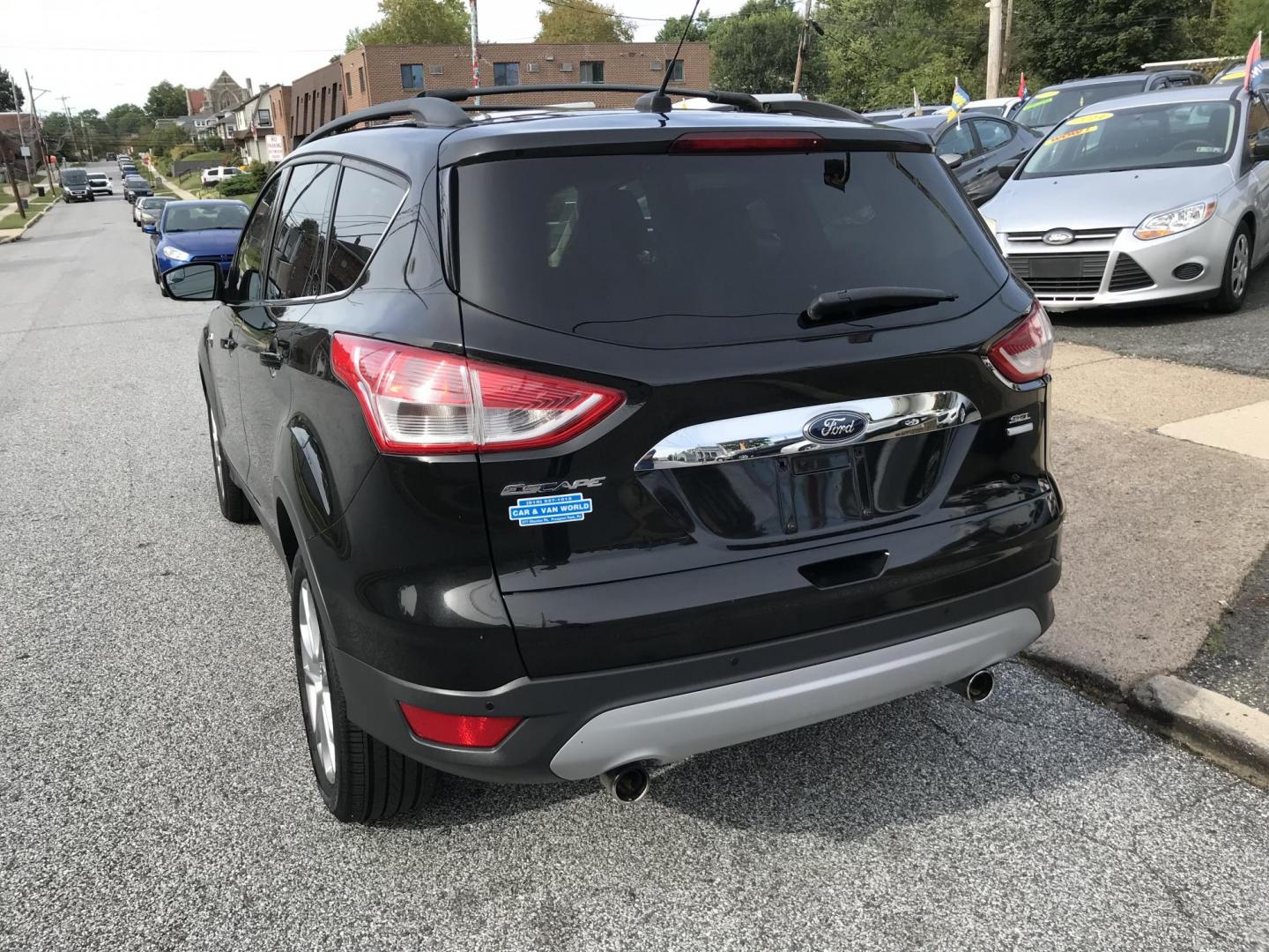2013 Black /Tan Ford Escape SEL 4WD (1FMCU9H98DU) with an 2.0L L4 DOHC 16V engine, 6-Speed Automatic transmission, located at 577 Chester Pike, Prospect Park, PA, 19076, (610) 237-1015, 39.886154, -75.302338 - Photo#4